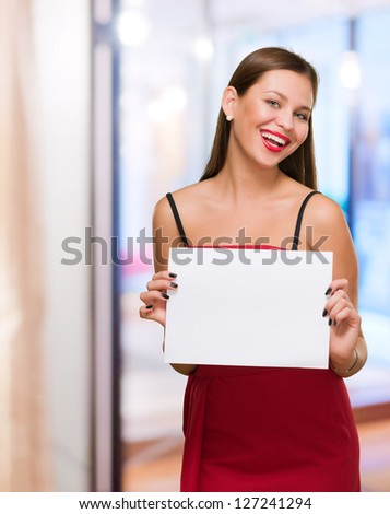 Happy Young Woman Holding Blank Placard, indoor
