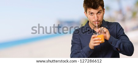 Young Man Drinking Juice Isolated, Outdoors