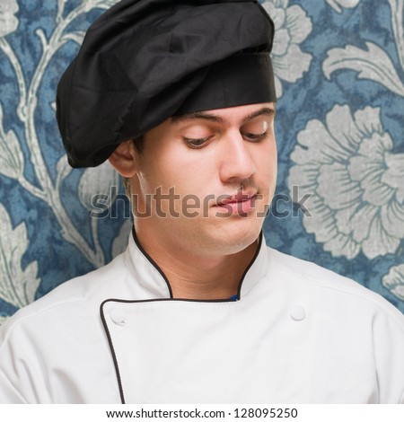 Portrait Of A Handsome Chef With Writing Pad against a vintage background