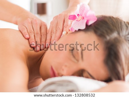 Attractive Woman Having A Massage With Massage Oil In A Spa