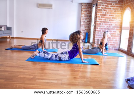 Similar – Image, Stock Photo Arab woman doing Upward facing dog asana on embankment