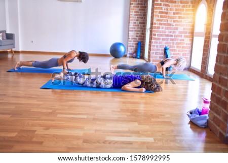 Similar – Image, Stock Photo Arab woman doing Upward facing dog asana on embankment