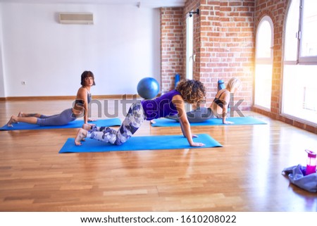 Similar – Image, Stock Photo Arab woman doing Upward facing dog asana on embankment
