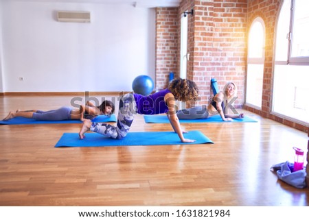 Similar – Image, Stock Photo Arab woman doing Upward facing dog asana on embankment