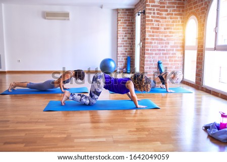 Similar – Image, Stock Photo Arab woman doing Upward facing dog asana on embankment