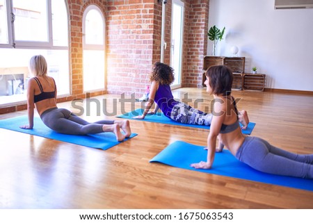 Similar – Image, Stock Photo Arab woman doing Upward facing dog asana on embankment