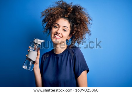 Similar – Image, Stock Photo Content sportswoman with water bottle taking selfie on smartphone