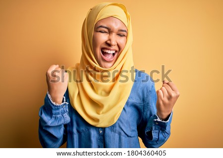 Similar – Image, Stock Photo Cheerful Arab woman with headphones on embankment
