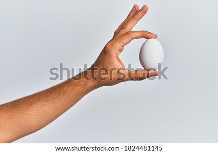 Similar – Foto Bild Hand hält ein Ei mit gemaltem Gesicht darauf. Ostern.