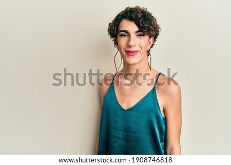 Young transgender man wearing make up and woman clothes, looking fashion and glamorous