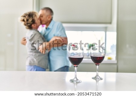 Similar – Image, Stock Photo Couple kissing in kitchen on counter