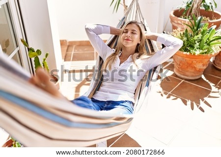 Similar – Image, Stock Photo Woman relaxing in hammock near lake