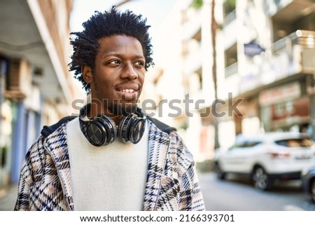 Similar – Image, Stock Photo Trendy black guy standing against city building