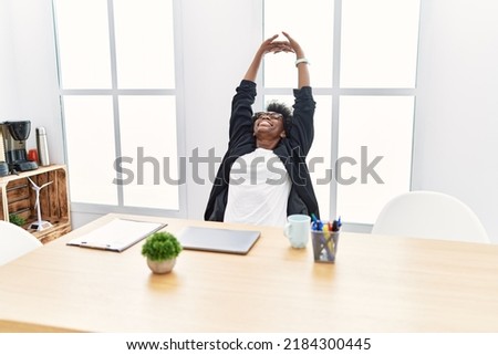 Young african american woman relaxing stretching arms at office Photo stock © 