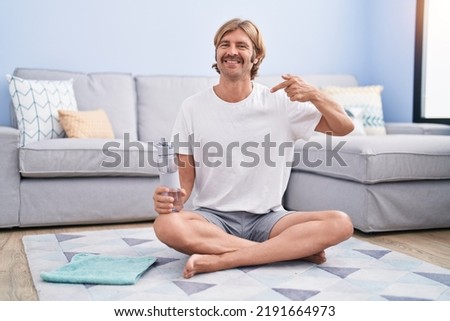 Caucasian man with mustache relaxing at living room pointing finger to one self smiling happy and proud  Stock foto © 