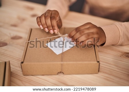 African american woman ecommerce business worker preparing, package at office Foto stock © 