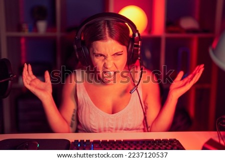 Similar – Image, Stock Photo Unhappy girl playing video game in evening time