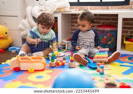 Similar – Image, Stock Photo Serious kid playing with toy at home