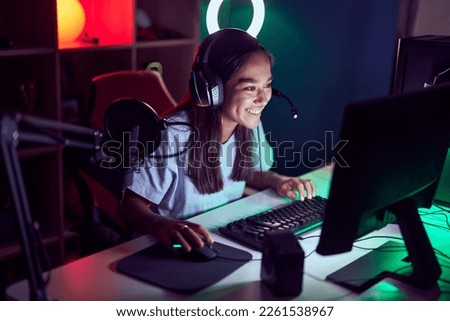 Similar – Image, Stock Photo Futuristic happy female in stylish outfit standing in studio with neon illumination