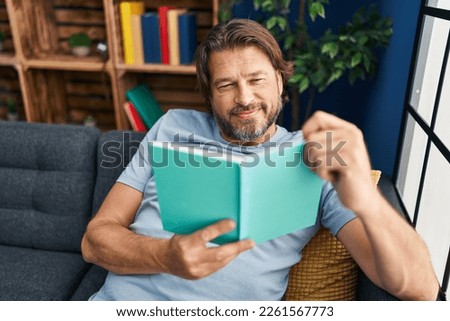 Similar – Image, Stock Photo Mature man reading book at home