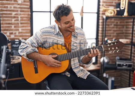 Similar – Image, Stock Photo Person playing guitar and recording the audio using microphone and technology at home. Amateur musician recording music.