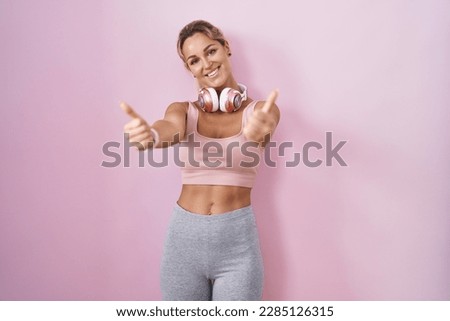 Similar – Image, Stock Photo Beautiful blonde woman doing home workout indoors. Woman practice yoga at home. Fit girl using workout tutorials for healthy active lifestyle. Woman using quarantine for home workouts.