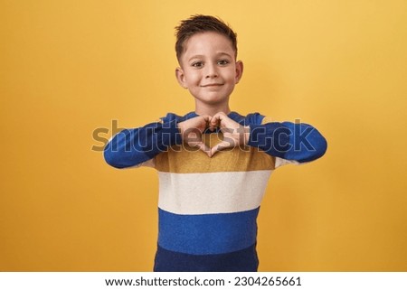 Similar – Image, Stock Photo Young boy is making a wooden  bird house in the carpenter workshop. Curious little sister is trying to see what he is doing behind his back