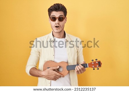 Image, Stock Photo Pensive man playing ukulele guitar