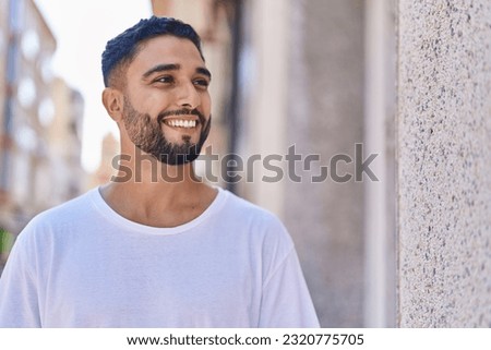 Similar – Image, Stock Photo Man with beard and plaid shirt of aesthetic lumberjack spreads his arms in the middle of nature with joy