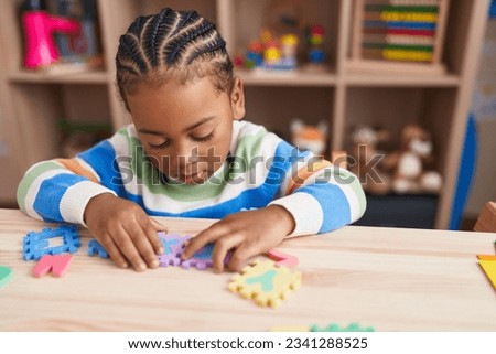 Similar – Image, Stock Photo Serious boy playing on smartphone