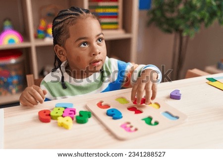 Similar – Image, Stock Photo Serious boy playing on smartphone