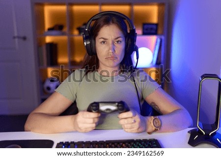 Image, Stock Photo Unhappy girl playing video game in evening time