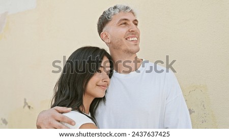 Similar – Image, Stock Photo Ethnic couple embracing against mirror in garden