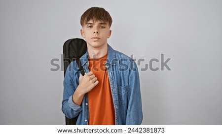 Image, Stock Photo Musician gazing and carrying guitar behind back while standing on beach