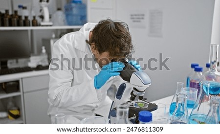 Similar – Image, Stock Photo Focused scientist examining chemical solution in laboratory