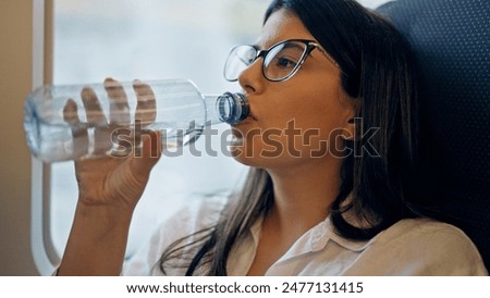 Similar – Image, Stock Photo Traveling woman drinking water from river