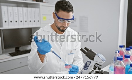 Similar – Image, Stock Photo Scientist working in the corona virus vaccine development laboratory research with a highest degree of protection gear.