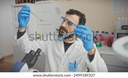 Similar – Image, Stock Photo Focused scientist examining chemical solution in laboratory