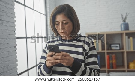 Similar – Image, Stock Photo Serious woman browsing smartphone at home