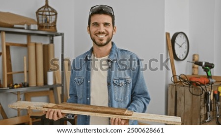 Similar – Image, Stock Photo Smiling workman in denim overall looking at camera