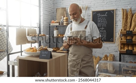 Foto Bild Kahlköpfiger Bäcker prüft Gebäck im Ofen