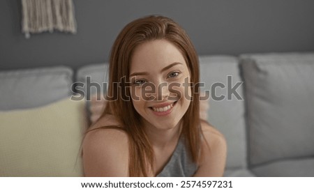 Similar – Image, Stock Photo Young redhead woman sit on grey linen fabric under orange coat with flowers and rowan berries