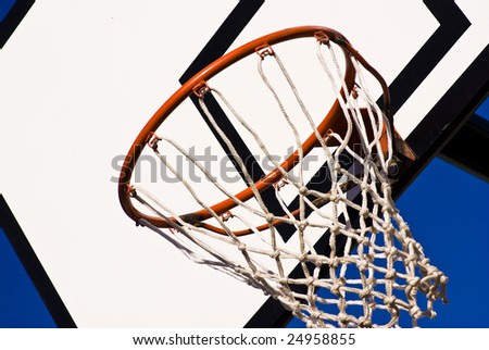 a basketball ring over a sunny blue sky