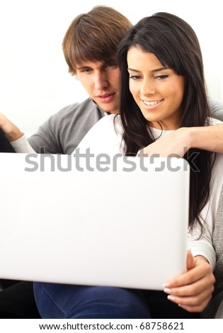 couple resting on the sofa with notebook pc
