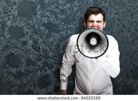 portrait of young man with megaphone against a vintage background