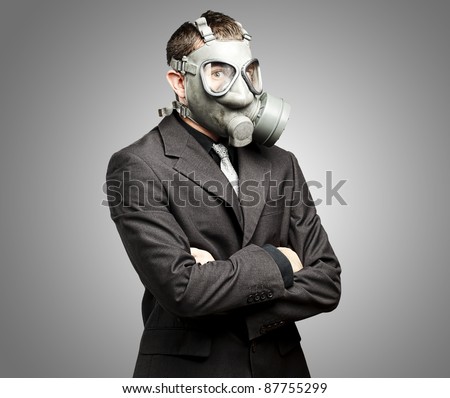 portrait of a business man with gas mask over grey background