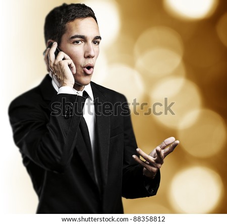 portrait of business man talking on mobile against a abstract background