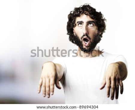 stock photo : young man imitating a zombie at living room