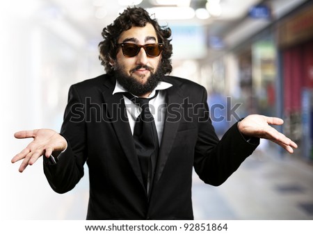portrait of young business man confused against a crowded place