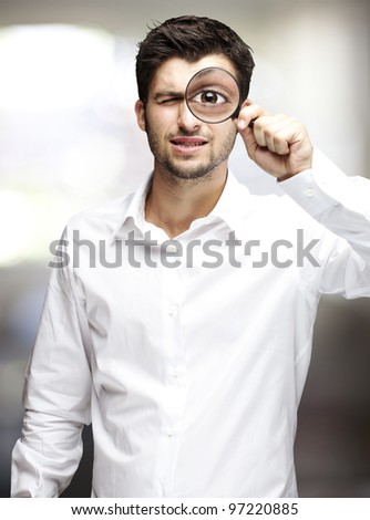 portrait of a young man with a magnifying glass, indoor